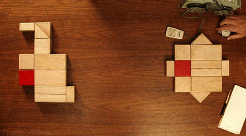 Two groups of the same wooden blocks are across from each other, anchored by one red block. They are not at all similar. From The Royal Tenenbaums.