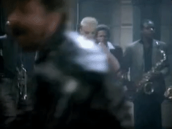 A svelte blonde dances in front of a band. [gif]