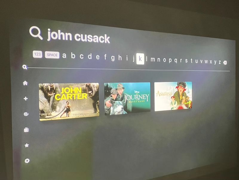 A photograph of the Disney+ search results, with the term "John Cusack" and only three movies: John Carter, The Journey of Natty Gann, and Anastasia.