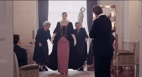 A gif from Phantom Thread of a woman presenting herself in a fashionable dress