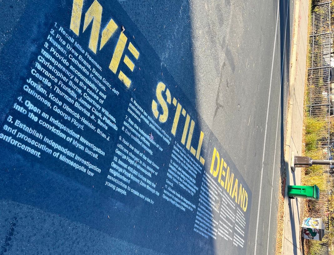 Spray-painted in the middle of the street, the demands of the protestors of George Floyd Square.